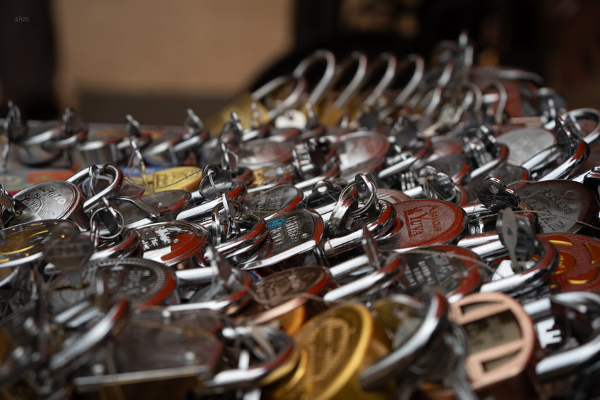 Rows of metal locks arranged on market trays.
